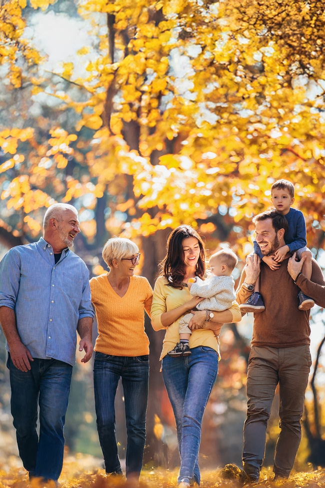 csmith-home-img1.3 Family walking under golden trees